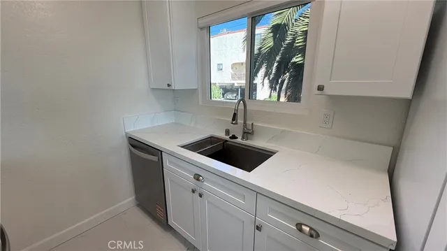 a kitchen with a sink and large window