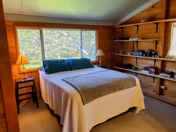 a bed sitting in a bedroom next to a window