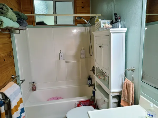 a bathroom with a bathtub and a shower