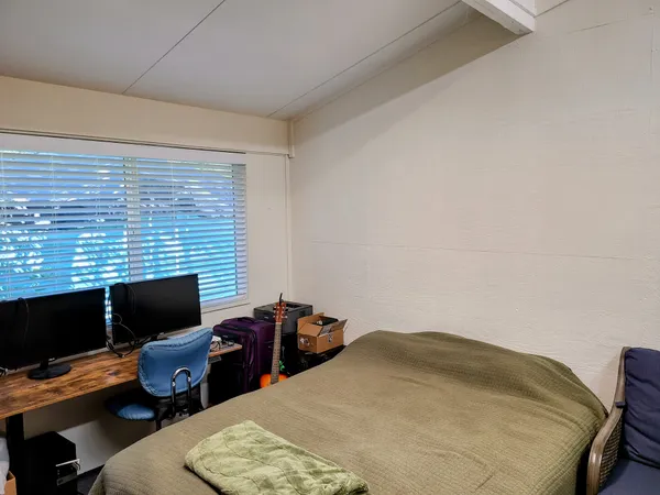 a bedroom with a bed and a flat screen tv