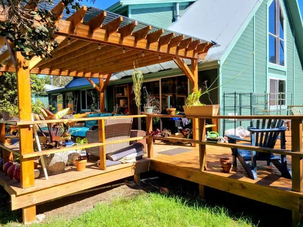 a view of a patio with table and chairs under an umbrella