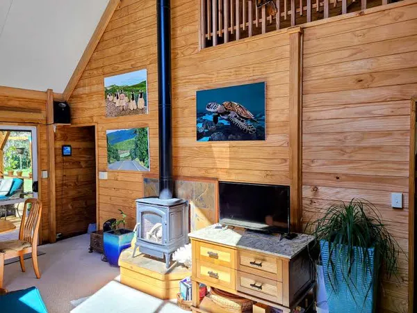 a view of a dinning room with furniture wooden floor and a fireplace