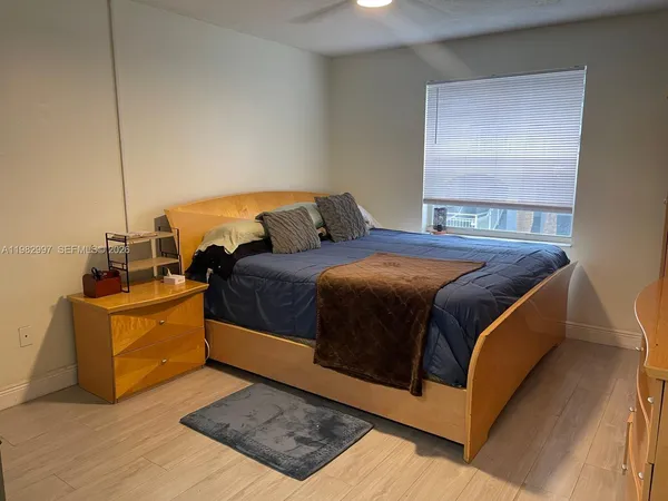 a bedroom with a bed and window