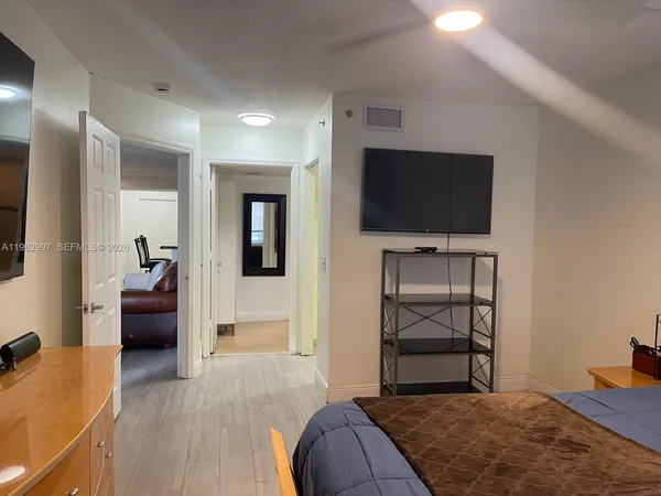 a bedroom with a bed and a television in it