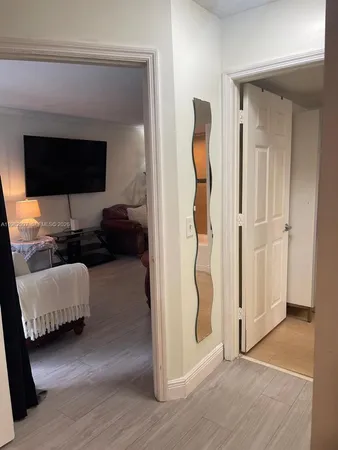 a living room with furniture and a walk in closet