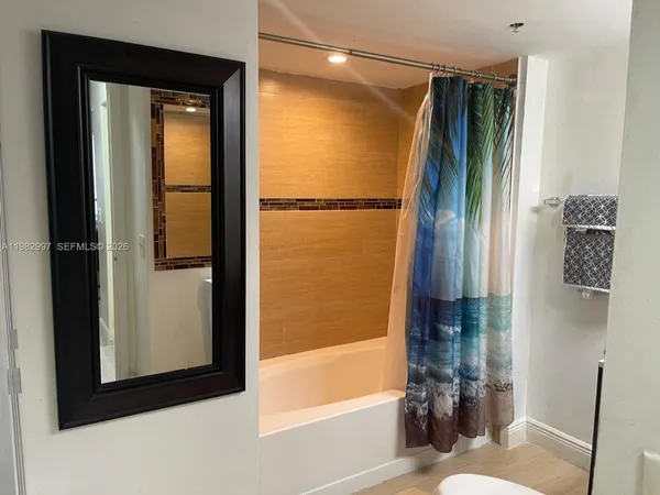 a bathroom with a glass shower door