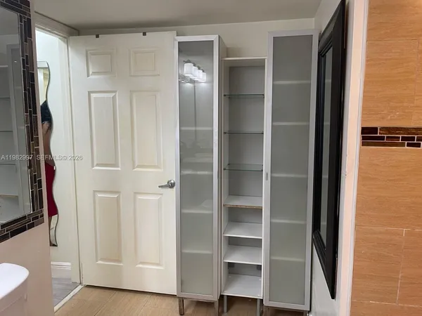 a view of walk in closet with empty racks