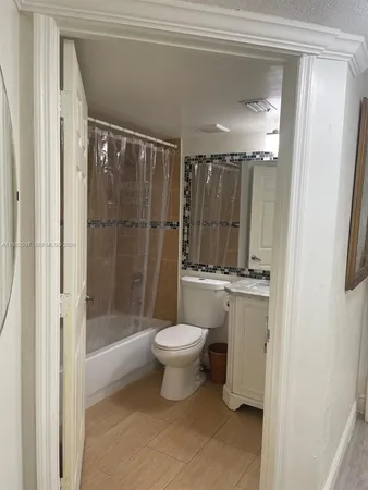 a bathroom with a shower a toilet and a sink