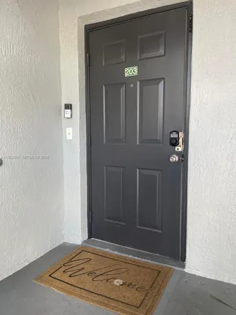 a view of front door of house with stairs
