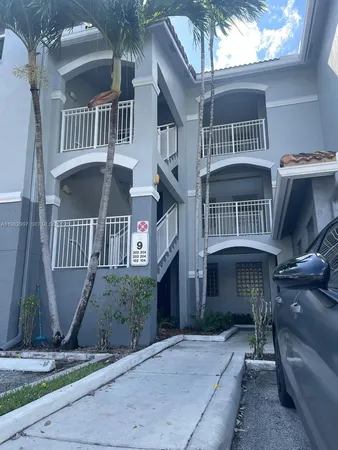 a front view of a house with fountain table and chairs