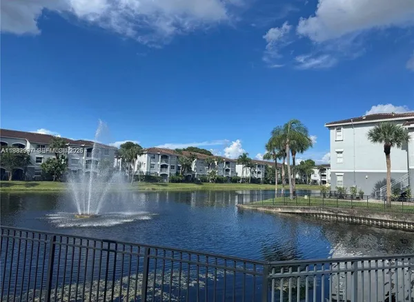 a brick building with a bench and a potted plant