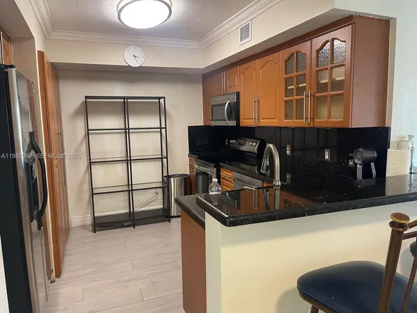 a kitchen with stainless steel appliances granite countertop a refrigerator and a sink