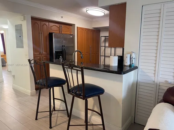 a view of a hallway with furniture and wooden floor
