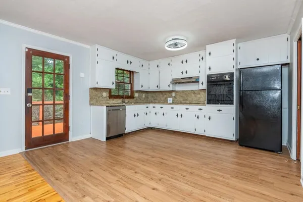 a kitchen with stainless steel appliances a refrigerator sink and cabinets