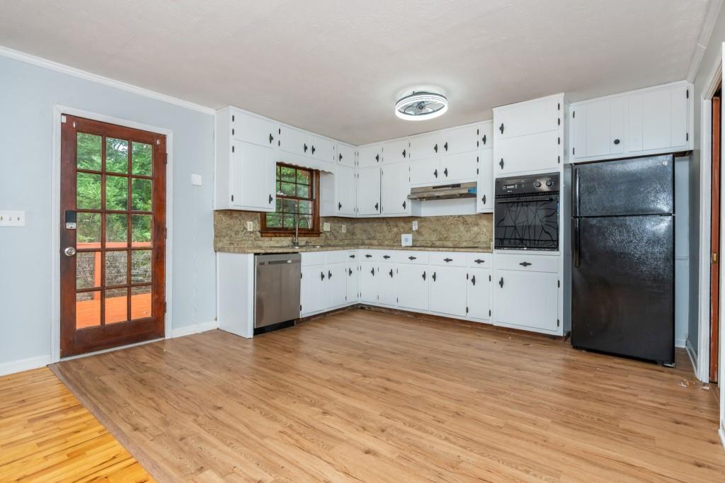 4043 Casa Loma Drive Decatur, GA 30034 - Photo 11 of 36 a kitchen with stainless steel appliances a refrigerator sink and cabinets