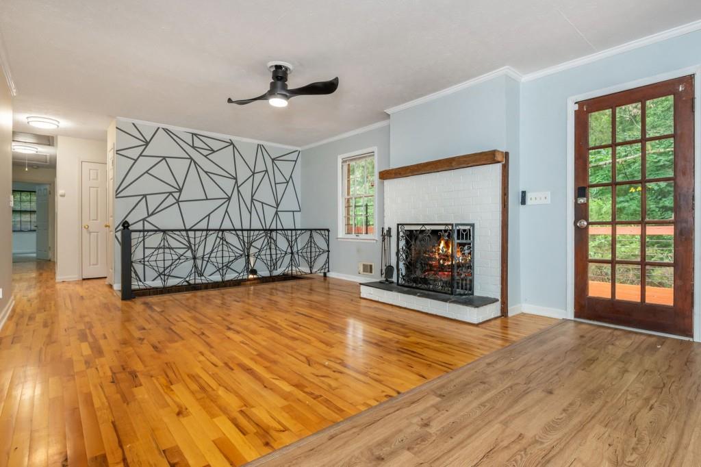 4043 Casa Loma Drive Decatur, GA 30034 - Photo 13 of 36 a view of a livingroom with wooden floor a fireplace and window
