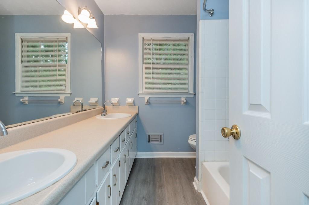 4043 Casa Loma Drive Decatur, GA 30034 - Photo 17 of 36 a bathroom with a sink a toilet a tub and a window