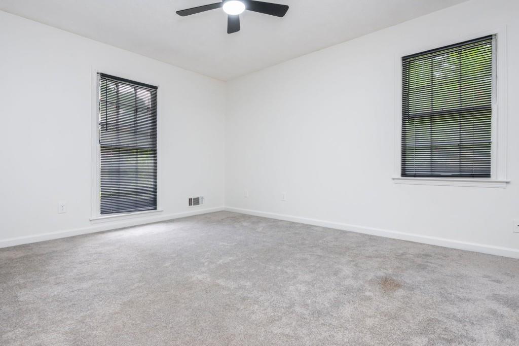 4043 Casa Loma Drive Decatur, GA 30034 - Photo 20 of 36 an empty room with windows and chandelier fan