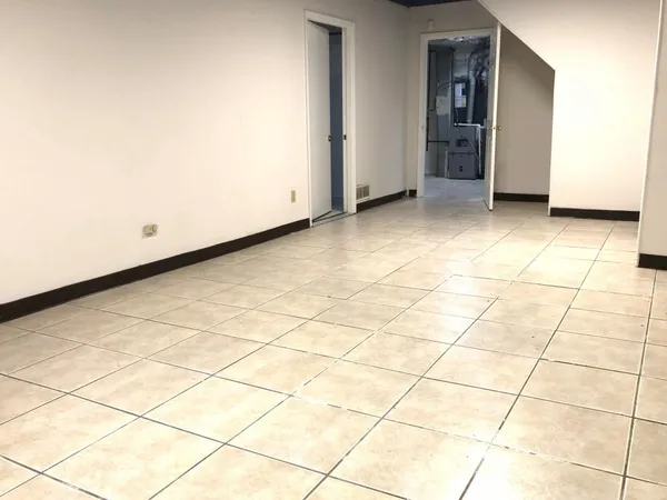 a view of a room and white wall and a refrigerator
