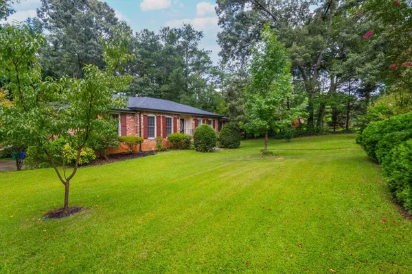 a view of a house with a backyard
