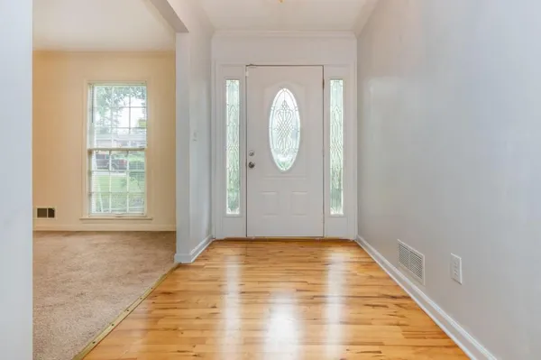 a view of a room with wooden floor and white walls