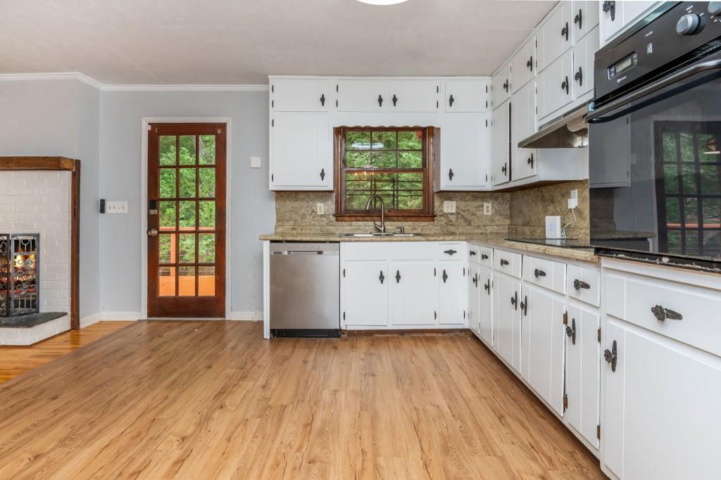 4043 Casa Loma Drive Decatur, GA 30034 - Photo 10 of 36 a kitchen with cabinets a window and stainless steel appliances