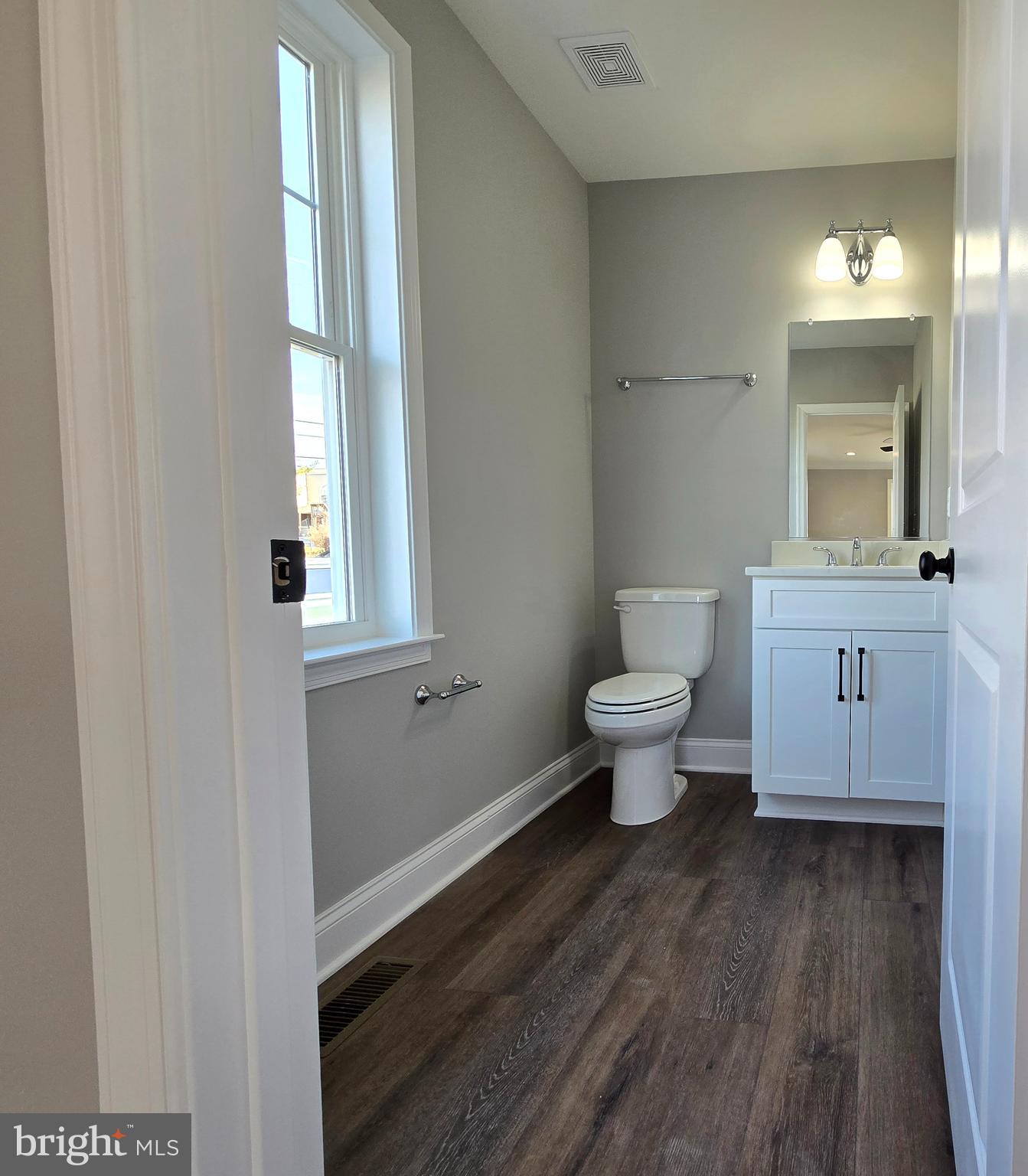 7704 Highpoint Road Clearwater Beach, MD 21226 - Photo 10 of 48 a bathroom with a toilet sink and a window