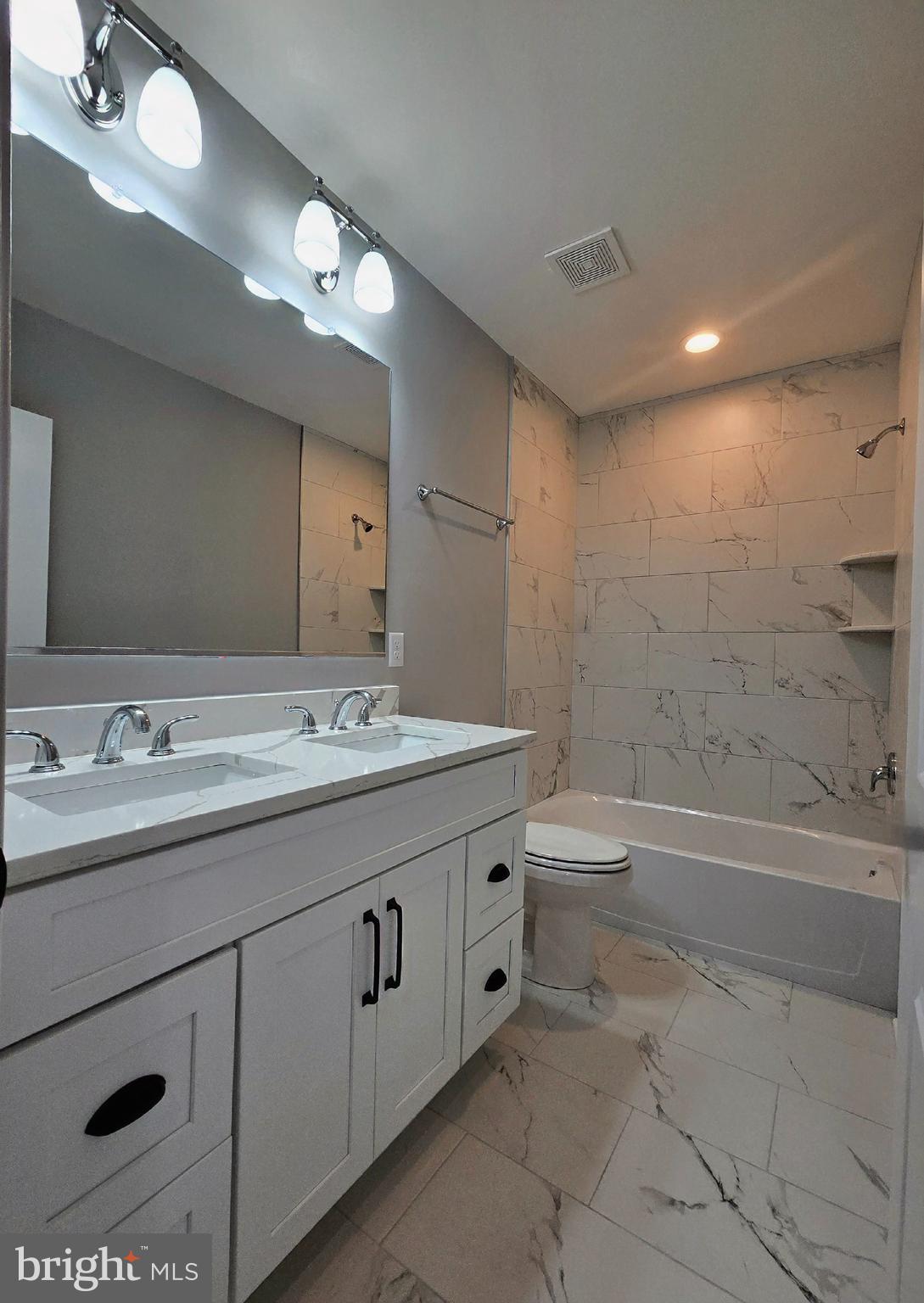 7704 Highpoint Road Clearwater Beach, MD 21226 - Photo 19 of 48 a bathroom with a granite countertop sink a toilet and bathtub