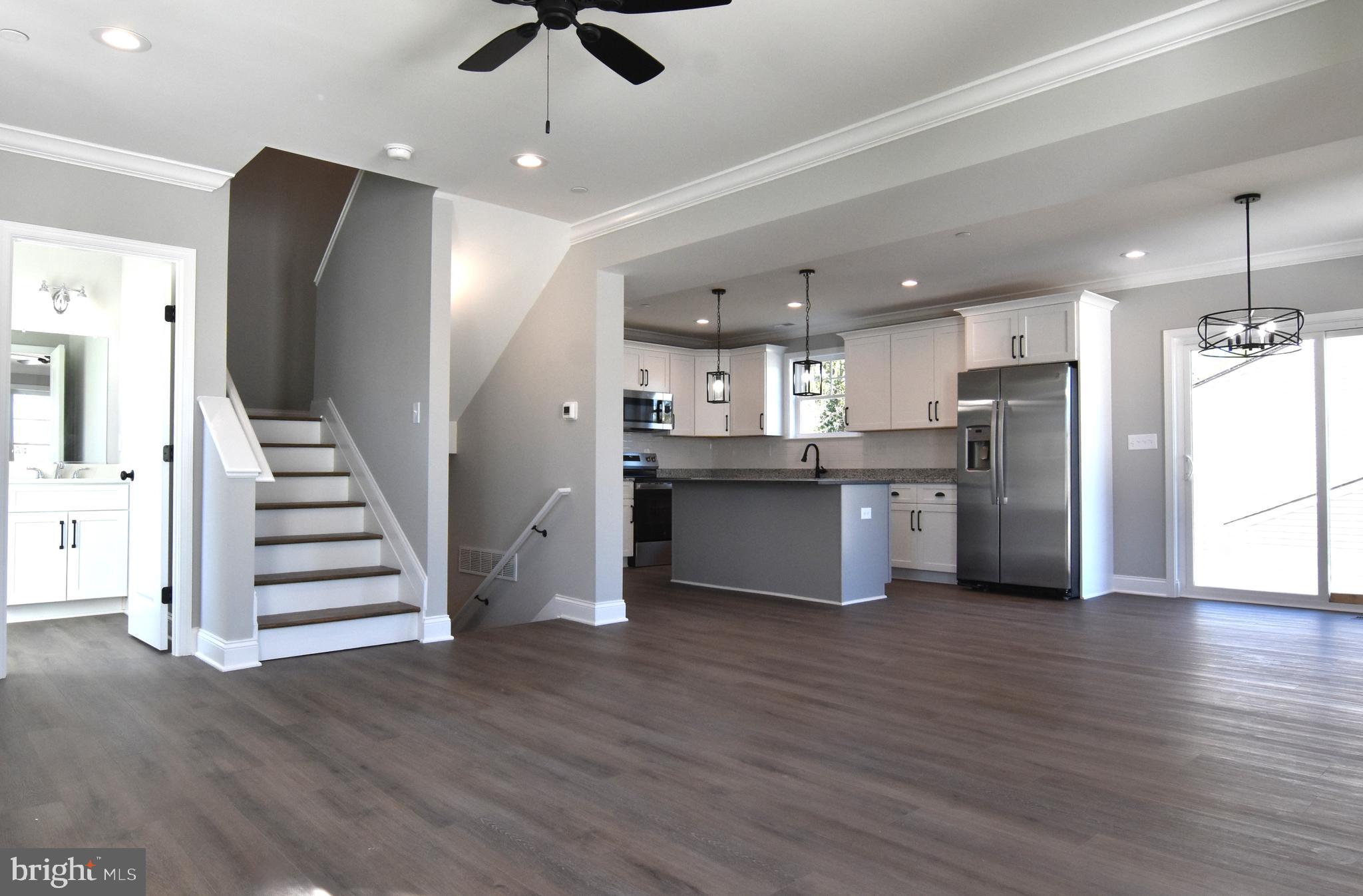 7704 Highpoint Road Clearwater Beach, MD 21226 - Photo 2 of 48 a view of kitchen with refrigerator microwave and wooden floor