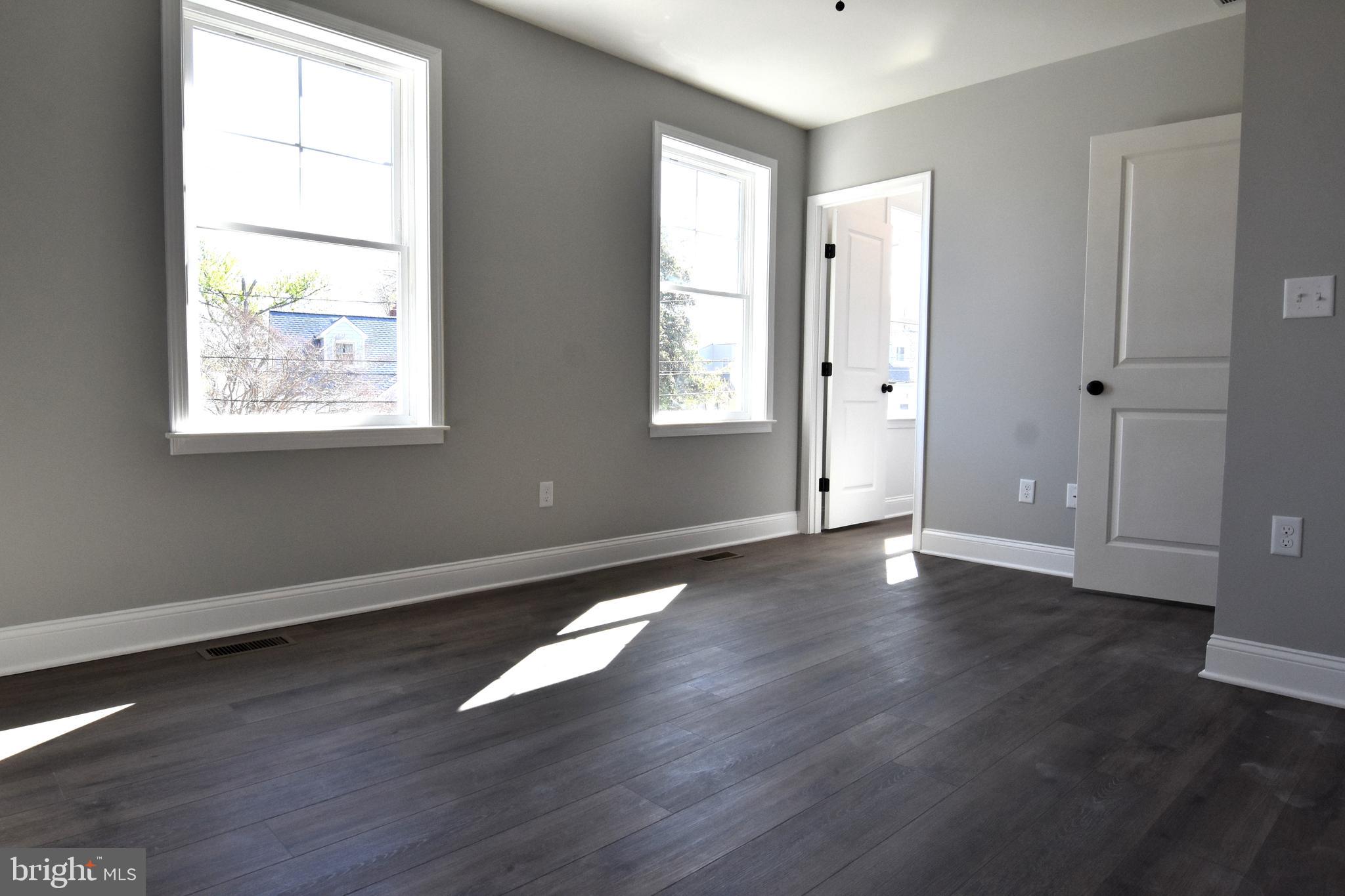 7704 Highpoint Road Clearwater Beach, MD 21226 - Photo 21 of 48 a view of an empty room with wooden floor and a window