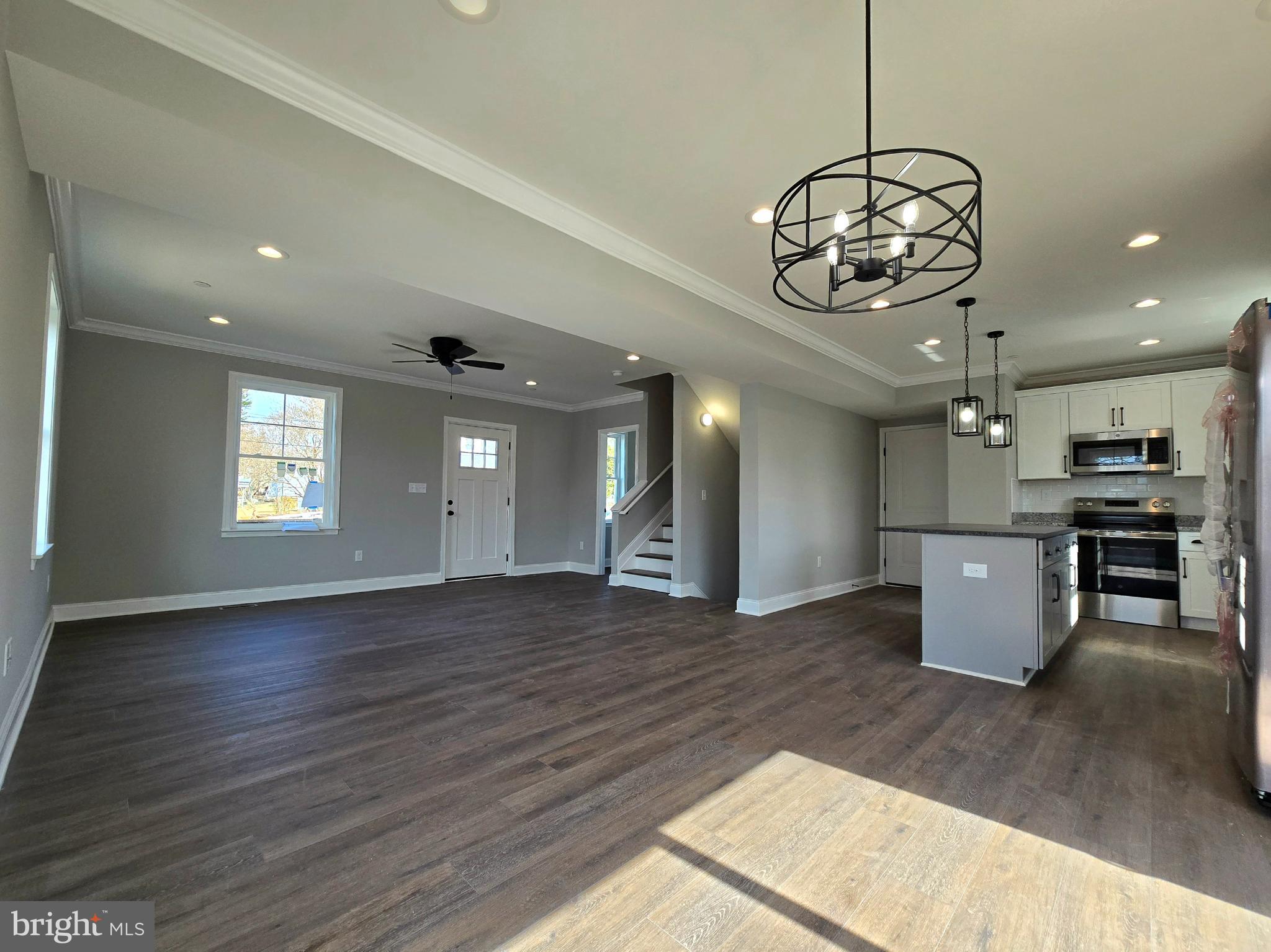 7704 Highpoint Road Clearwater Beach, MD 21226 - Photo 4 of 48 a view of a room with wooden floor kitchen and windows