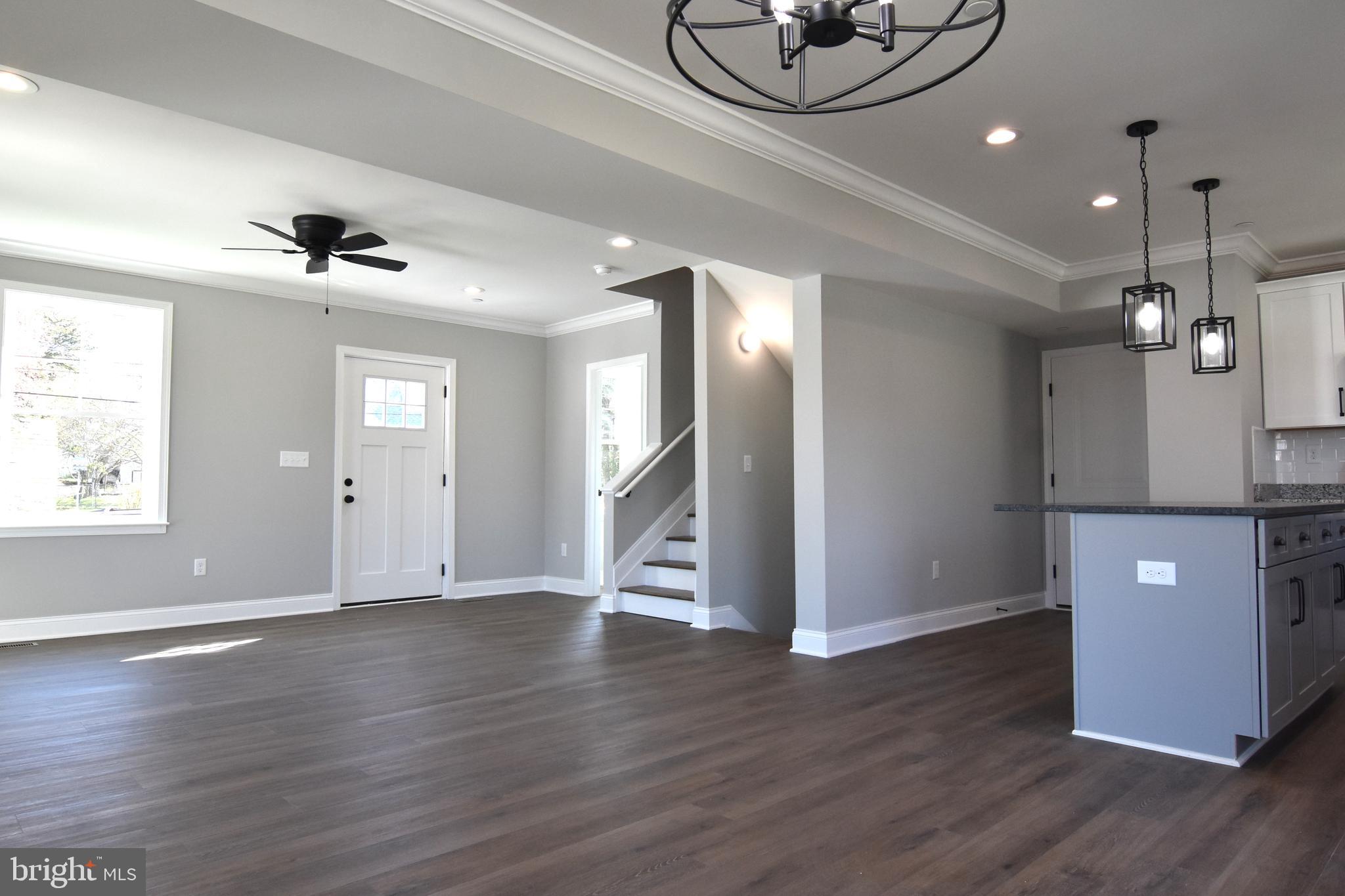 7704 Highpoint Road Clearwater Beach, MD 21226 - Photo 8 of 48 a view of an empty room with wooden floor and a ceiling fan
