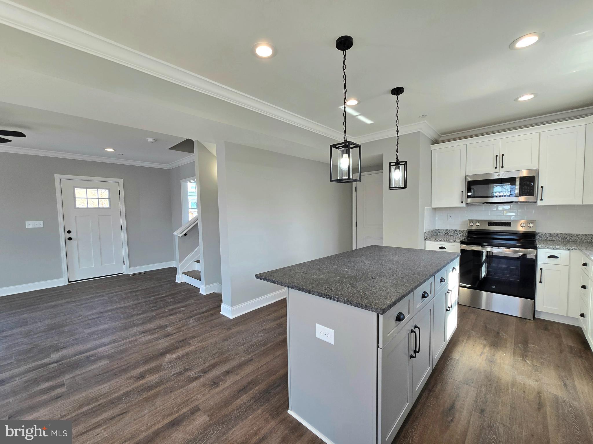7704 Highpoint Road Clearwater Beach, MD 21226 - Photo 9 of 48 a kitchen with stainless steel appliances granite countertop a sink a stove and a wooden floors