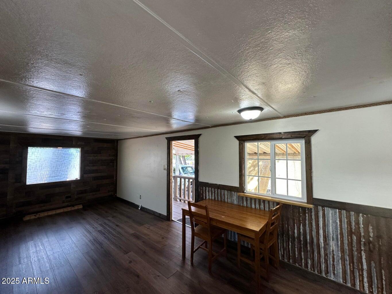 4230 North Az Highway Pine, AZ 85544 - Photo 3 of 15 an empty room with wooden floor and windows