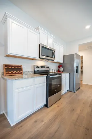a kitchen with stainless steel appliances a stove a sink and a refrigerator