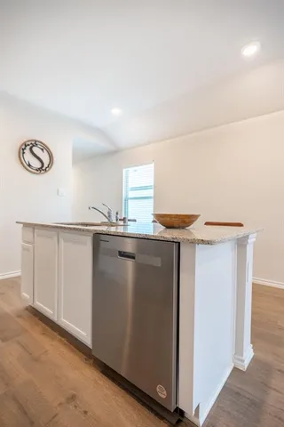 a kitchen with granite countertop a sink and a stove top oven