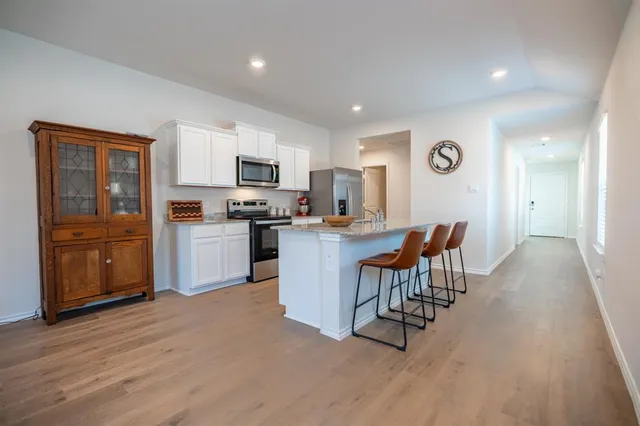 a kitchen with a sink a counter top space and appliances