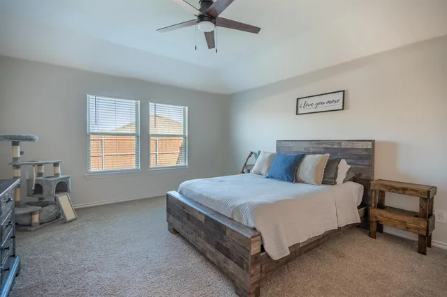 a spacious bedroom with a bed and window