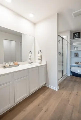a spacious bathroom with a double vanity sink and mirror