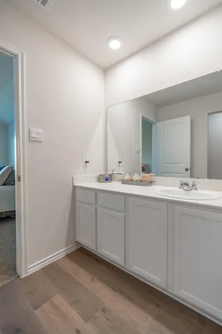a bathroom with double sink and a mirror