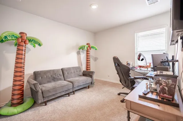 a living room with furniture a couch and a potted plant
