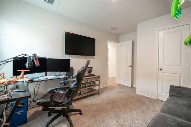 a view of a livingroom with workspace and a couch