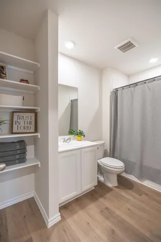 a bathroom with a sink toilet and shower