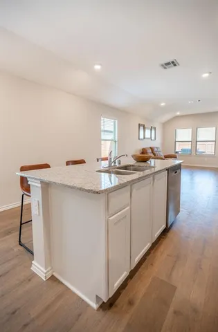 a kitchen with a sink cabinets and window