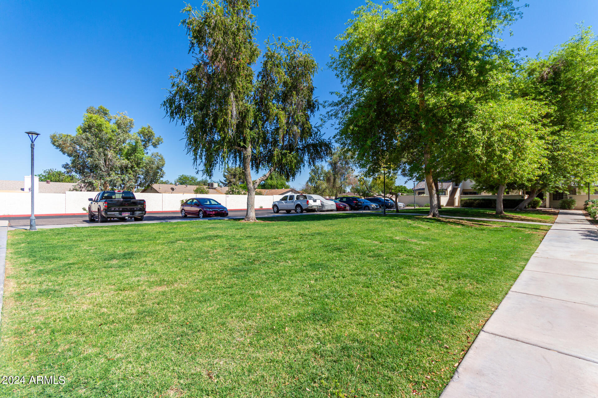 1222 West Baseline Road, Unit 240 Tempe, AZ 85283 - Photo 26 of 36 a front view of a building with garden