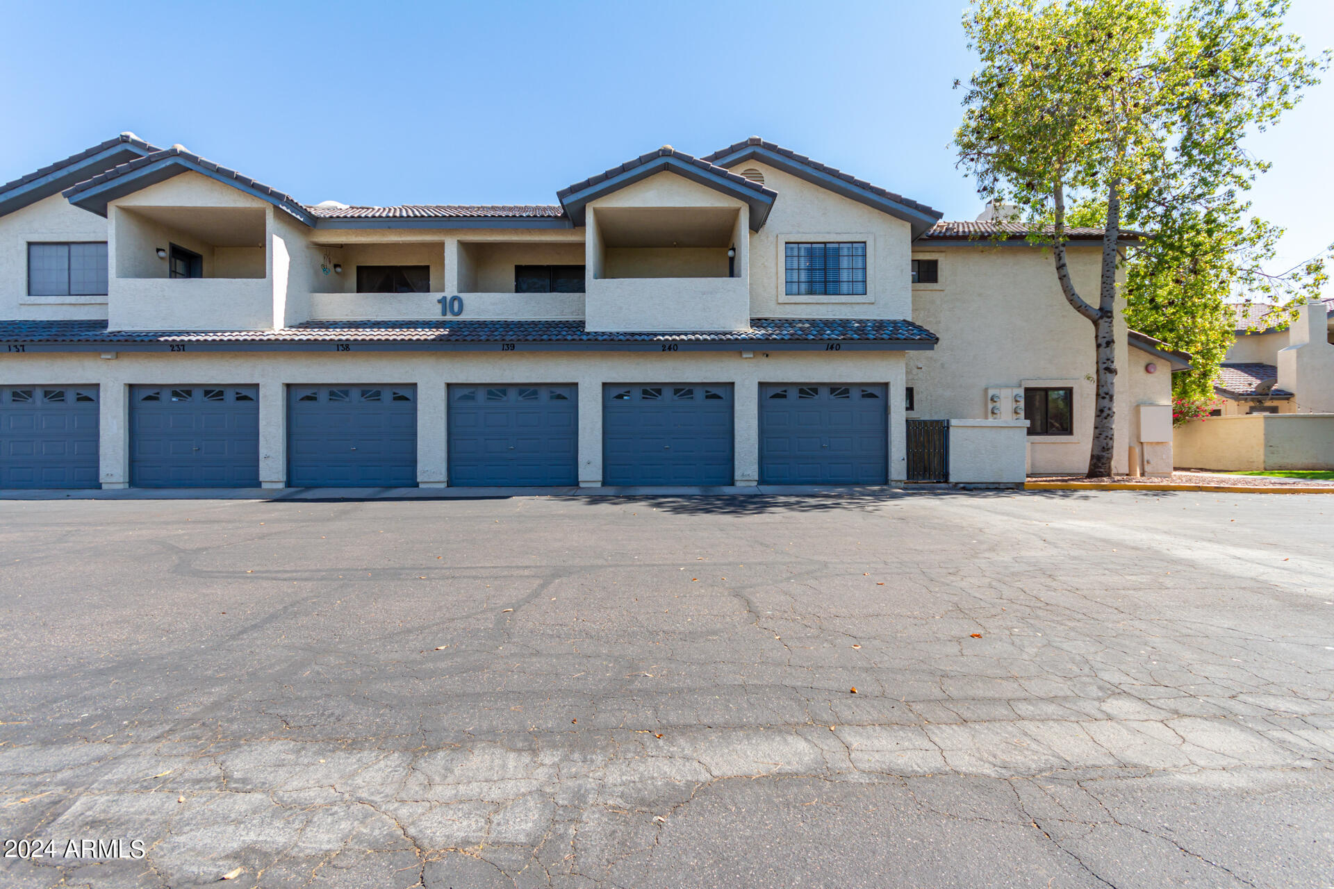 1222 West Baseline Road, Unit 240 Tempe, AZ 85283 - Photo 33 of 36 a front view of a house with a yard and garage