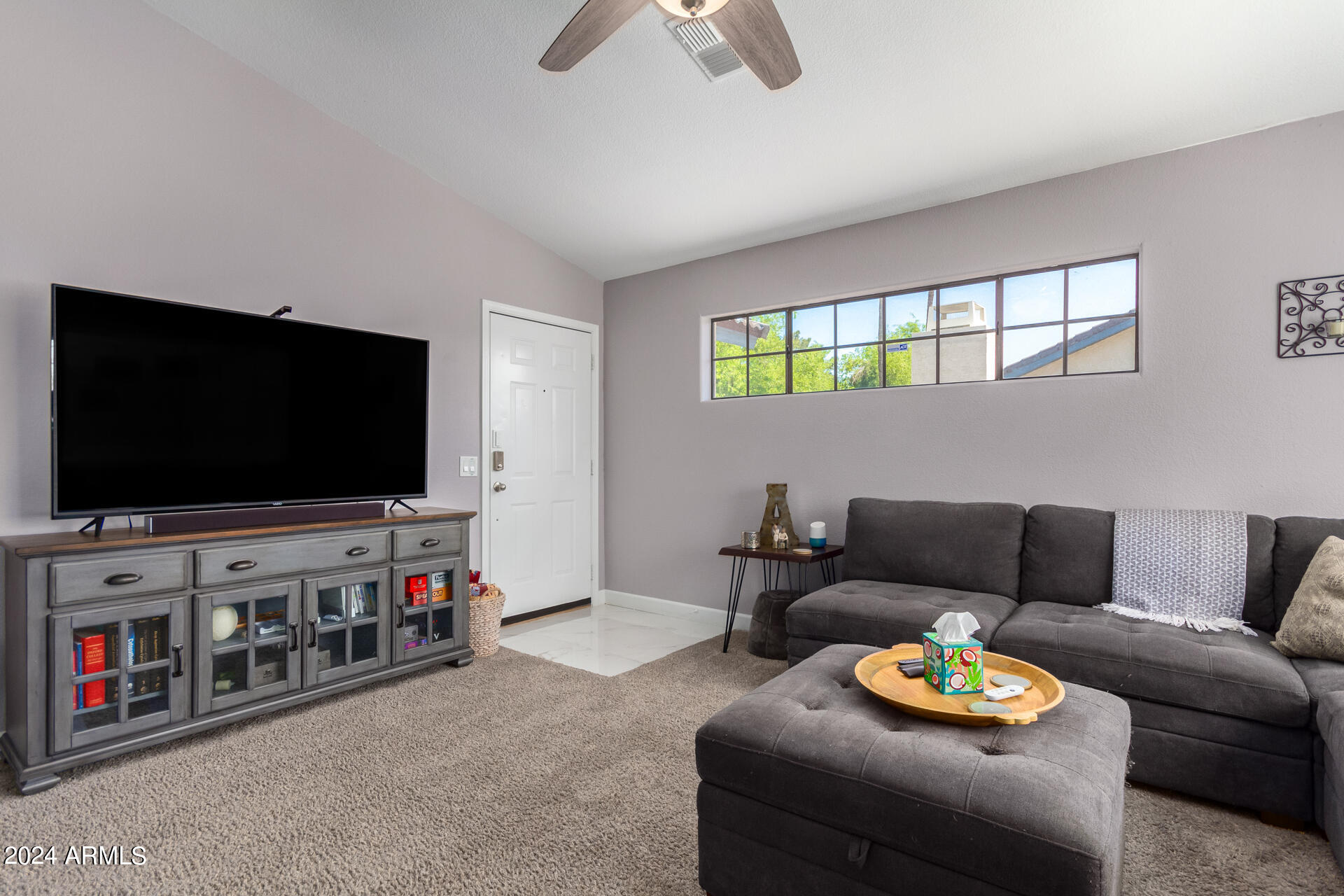 1222 West Baseline Road, Unit 240 Tempe, AZ 85283 - Photo 4 of 36 a living room with furniture and a flat screen tv