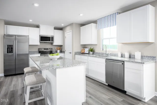a kitchen with a sink stove and refrigerator
