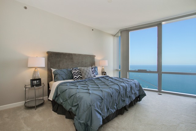 1211 South Prairie Avenue, Unit 5202 Chicago, IL 60605 - Photo 10 of 22 a bed sitting in a bedroom next to a window