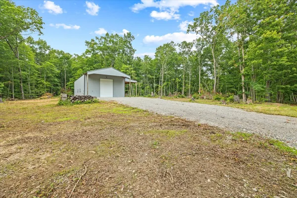 a backyard of a house with large trees